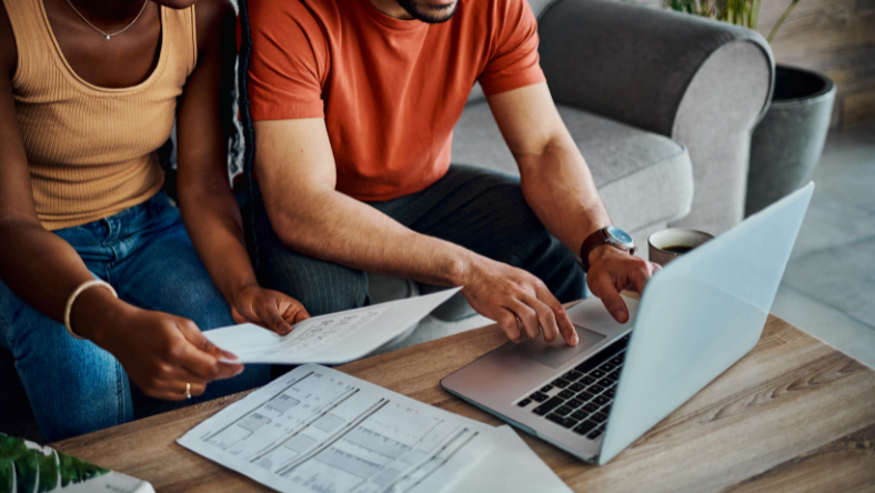 Couple working together with bills and laptop