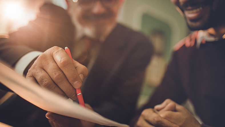 Two men reviewing a document