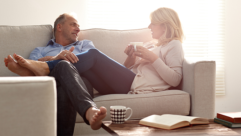 Mature couple relaxing on couch together.