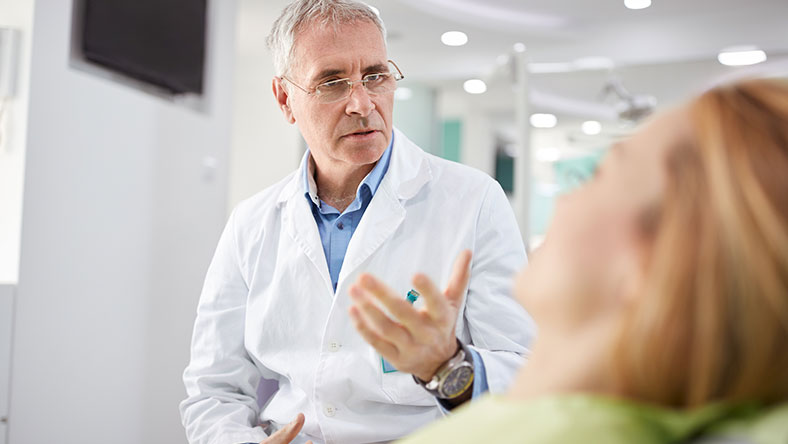 Doctor speaking with a woman in his office