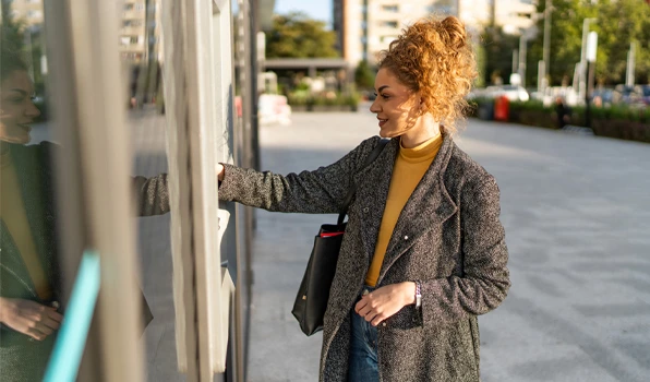 Customer accessing an ATM to withdraw cash and manage a checking account, highlighting convenient banking on the go.