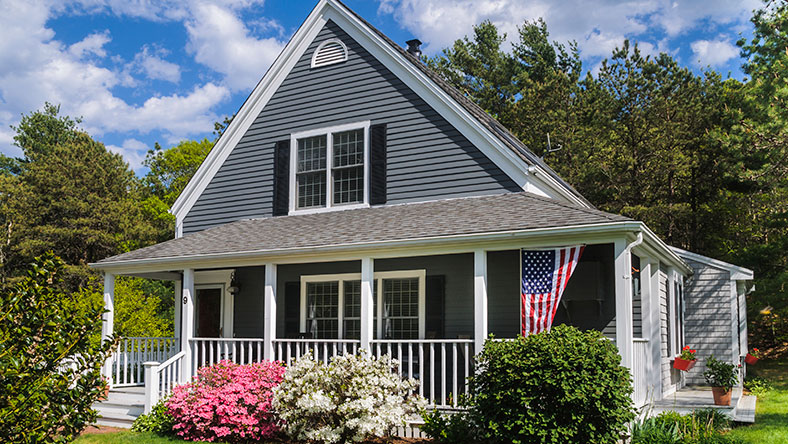 Gray house with white fence