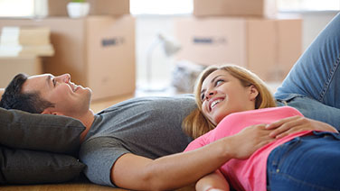 Couple laying on floor in new home