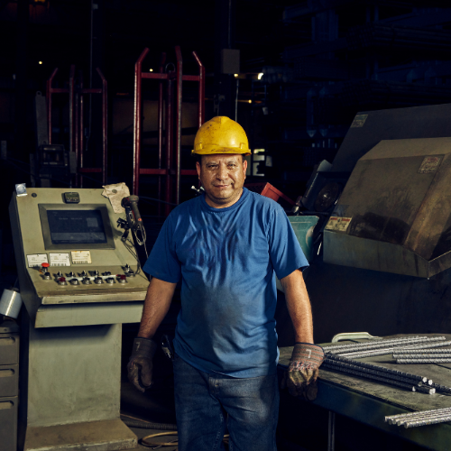 Steel worker man standing in workshop.